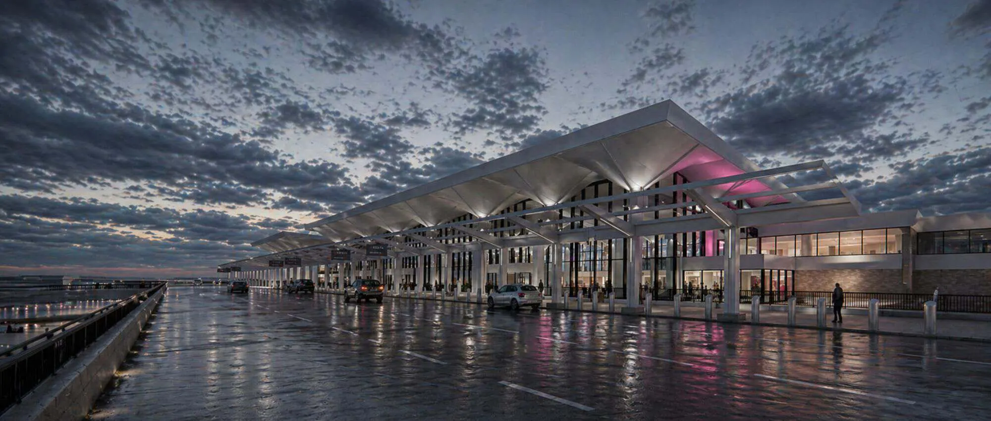 Rendering of the terminal at night, reflected in the wet roadway