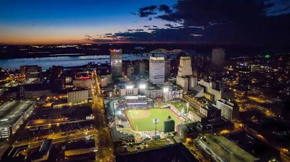 Aerial view of the lit ballpark downtown at dusk