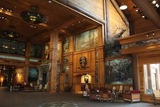 The lodge's great hall, timber-paneled and hung with mounts and paintings