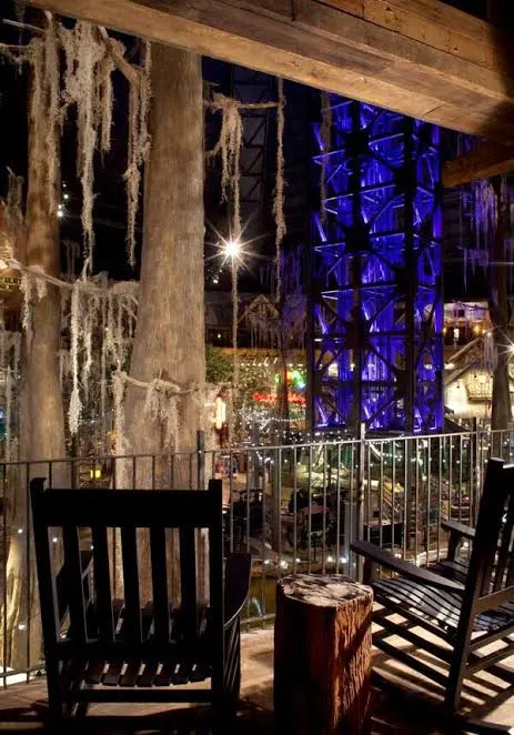 Rocking chairs on a guest balcony overlooking the cypress swamp
