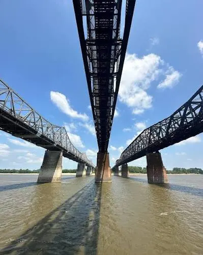 Looking up between two bridge decks from the river