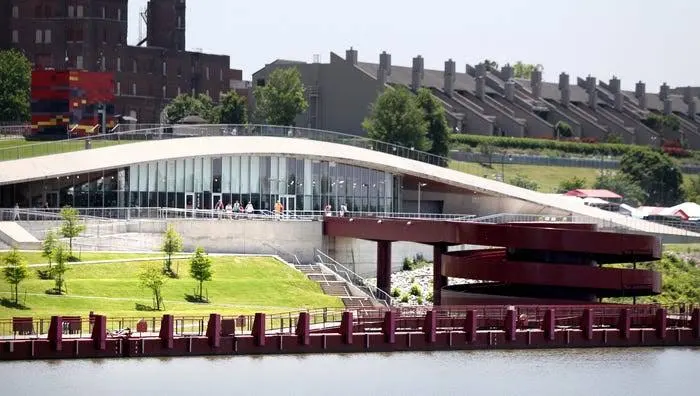 The landing's curving roof and red circular ramps