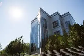 The curved glass corner of the building against the sun