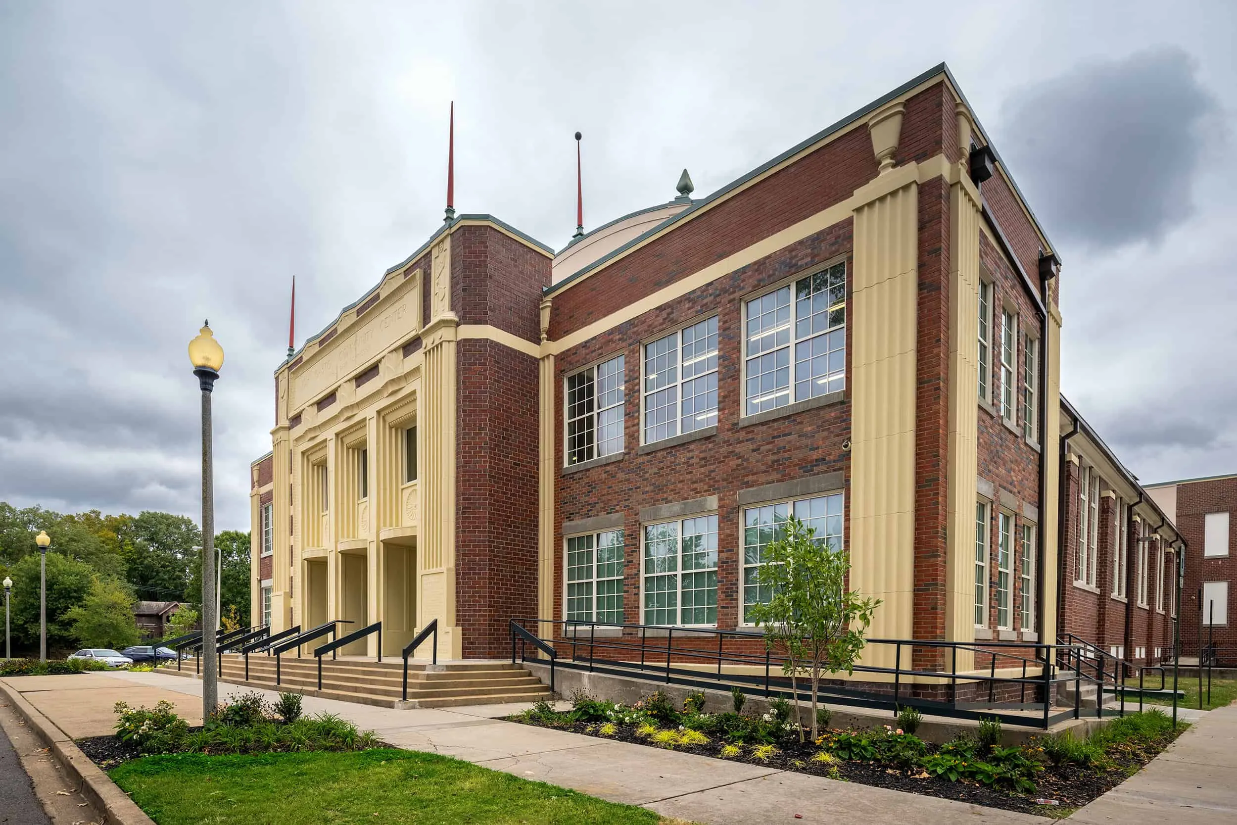 The restored brick and limestone wing under a cloudy sky