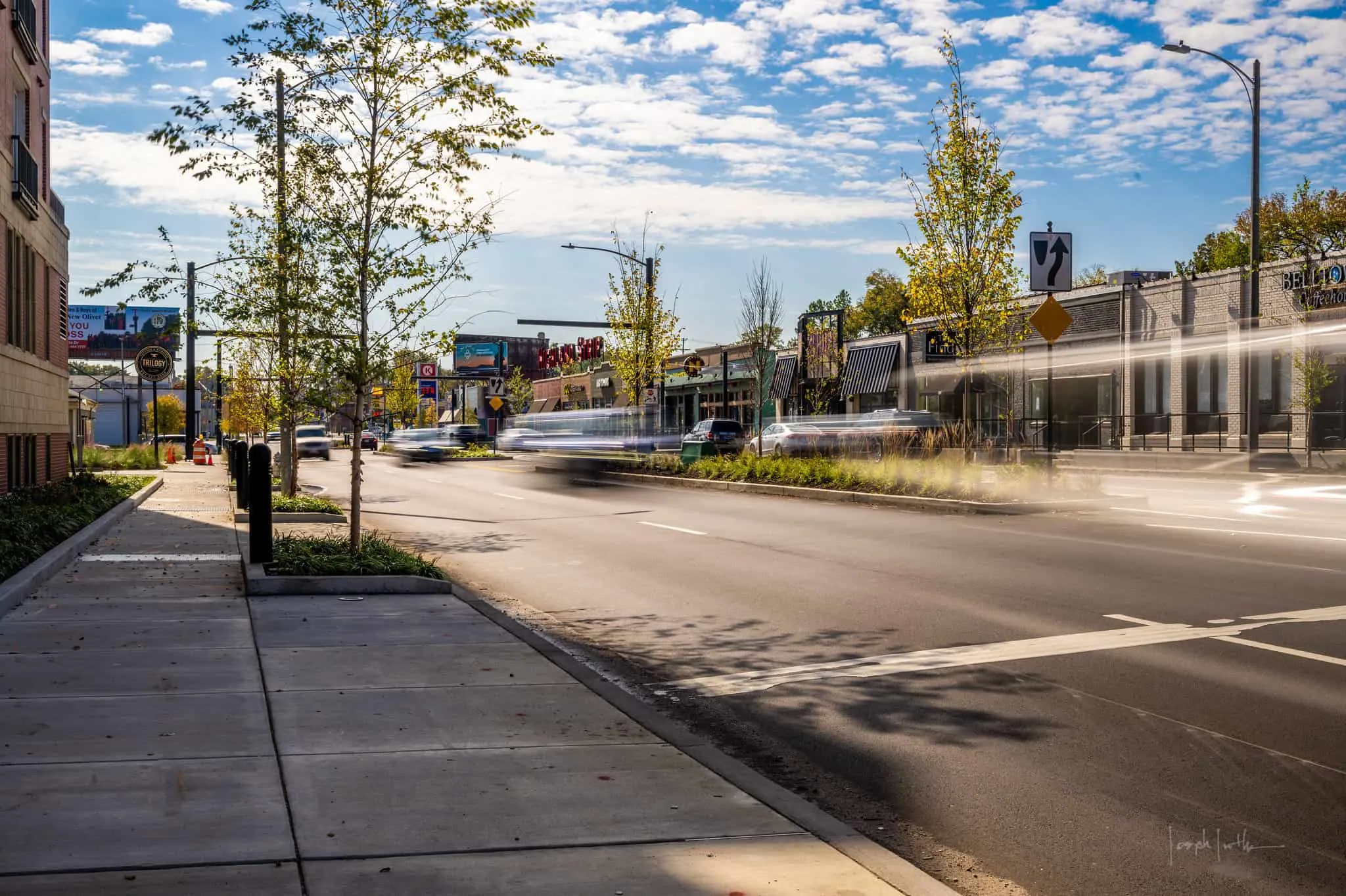 Widened sidewalk and young trees along Highland