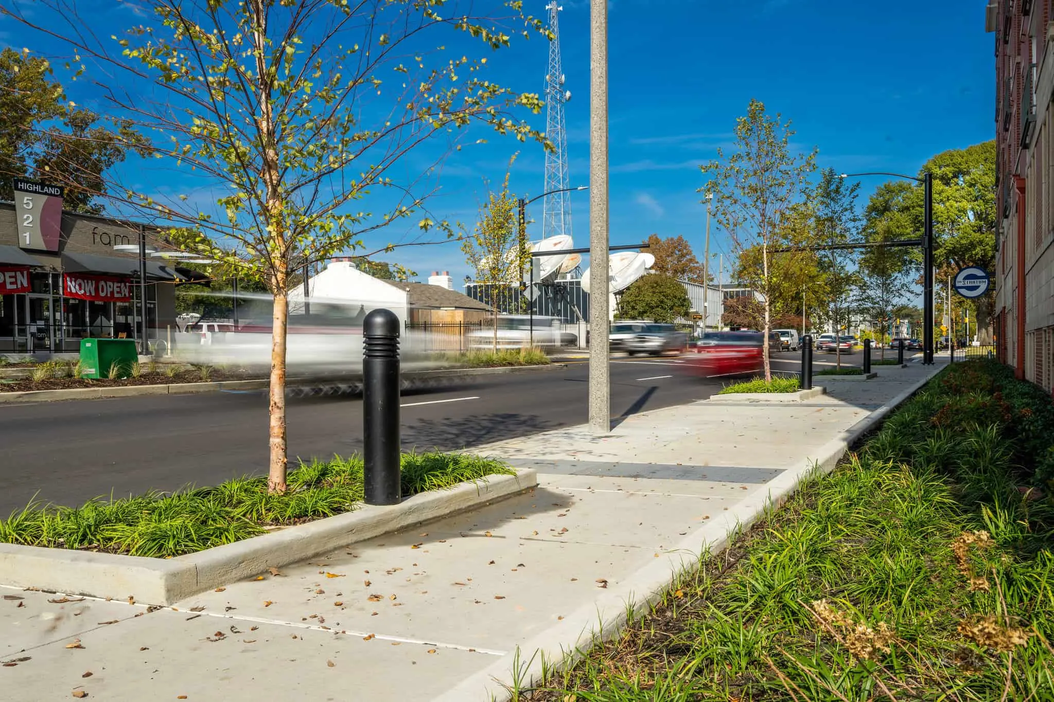 A planted curb beside the new sidewalk