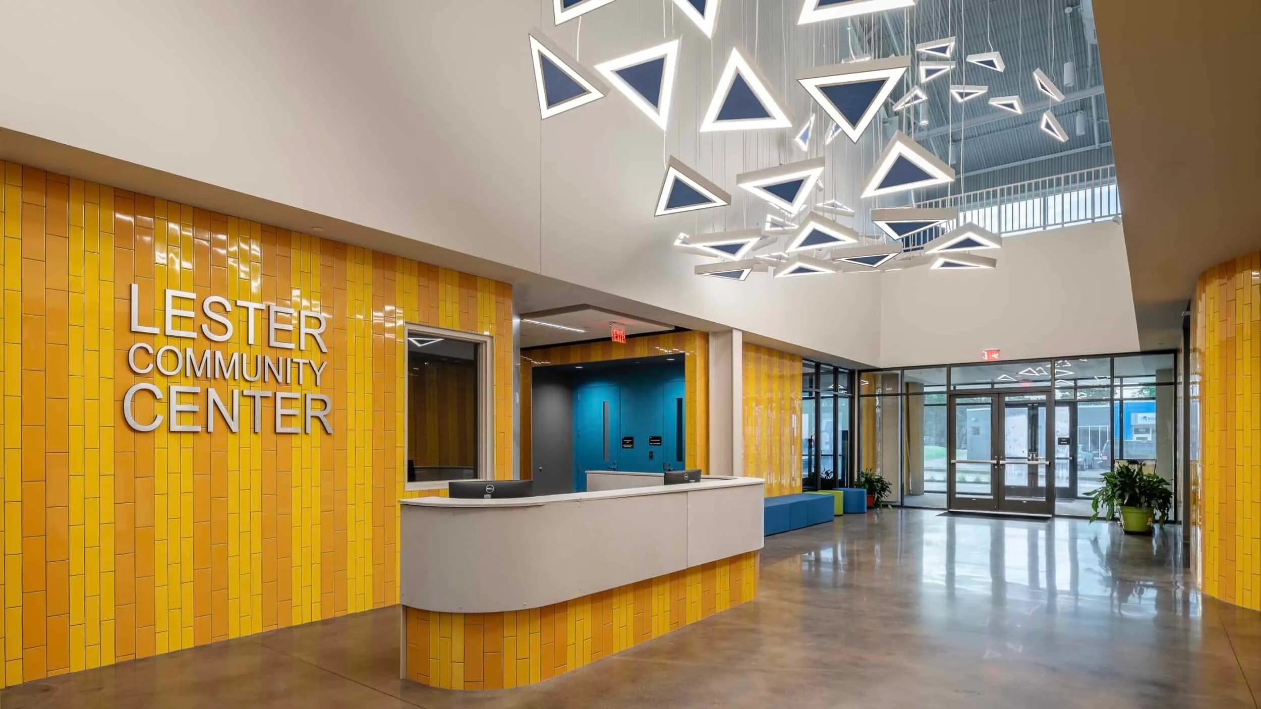 The lobby and front desk under a canopy of triangular lights