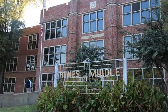 The brick front of a Memphis middle school behind its sign
