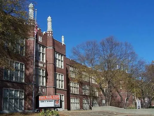 A historic brick high school with twin spires