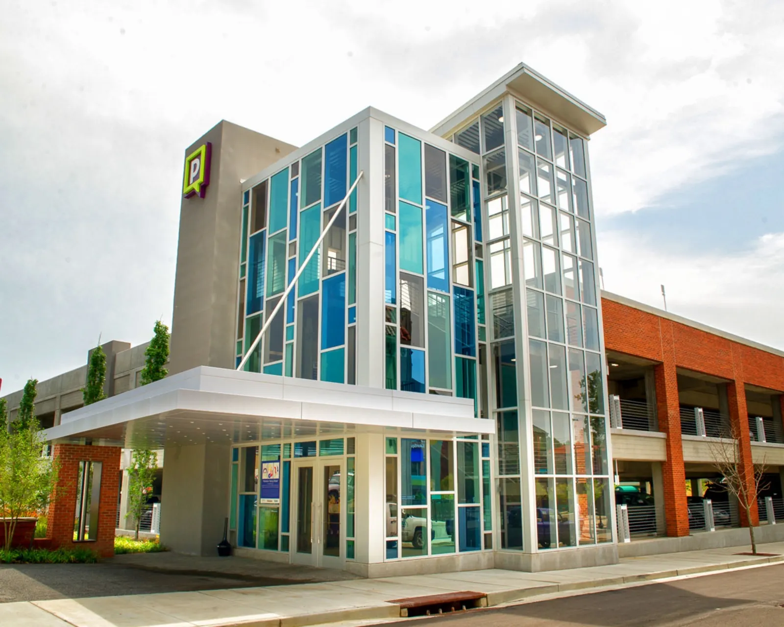The glass stair tower and entry canopy by day