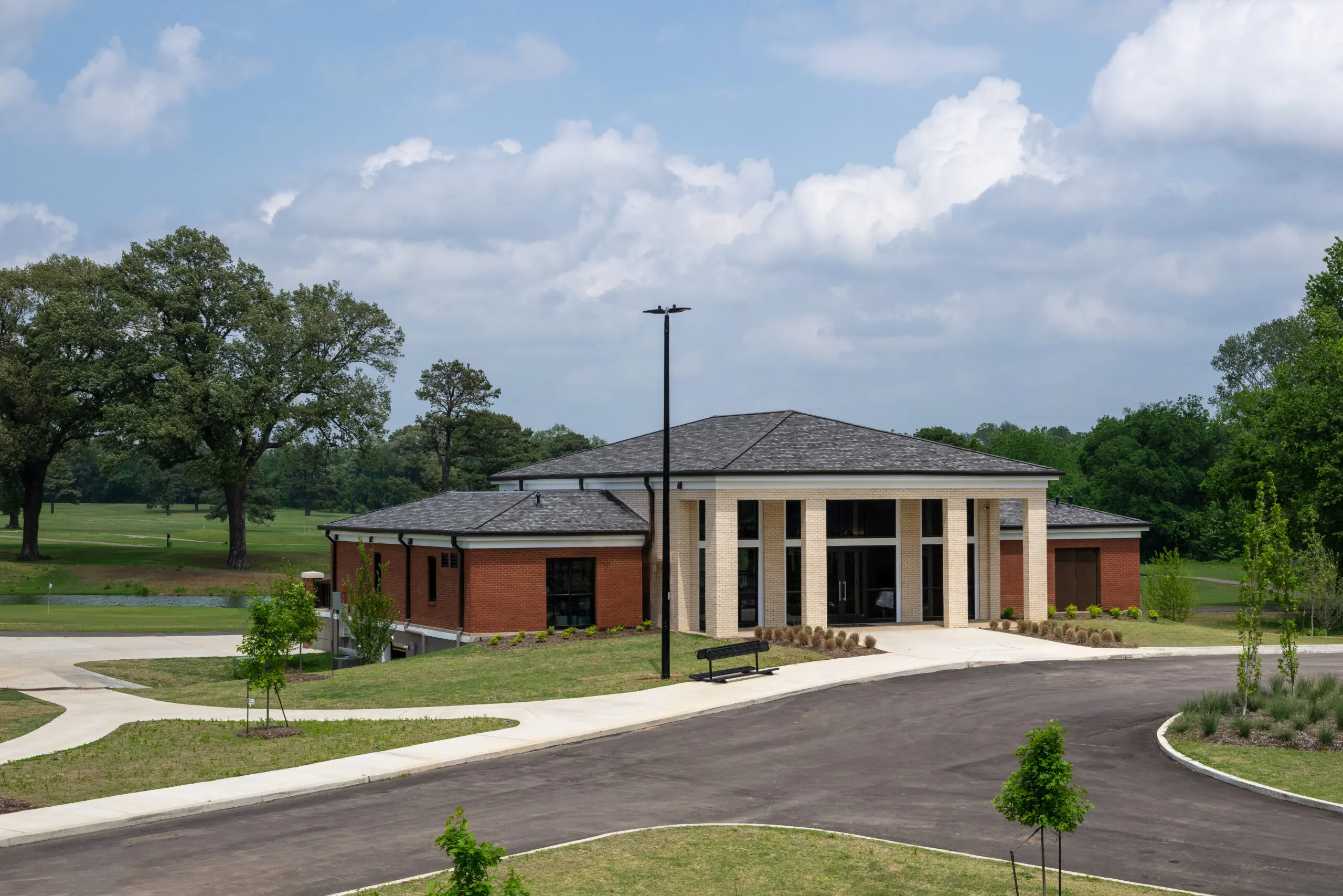 The clubhouse from the entry drive, under a bright sky