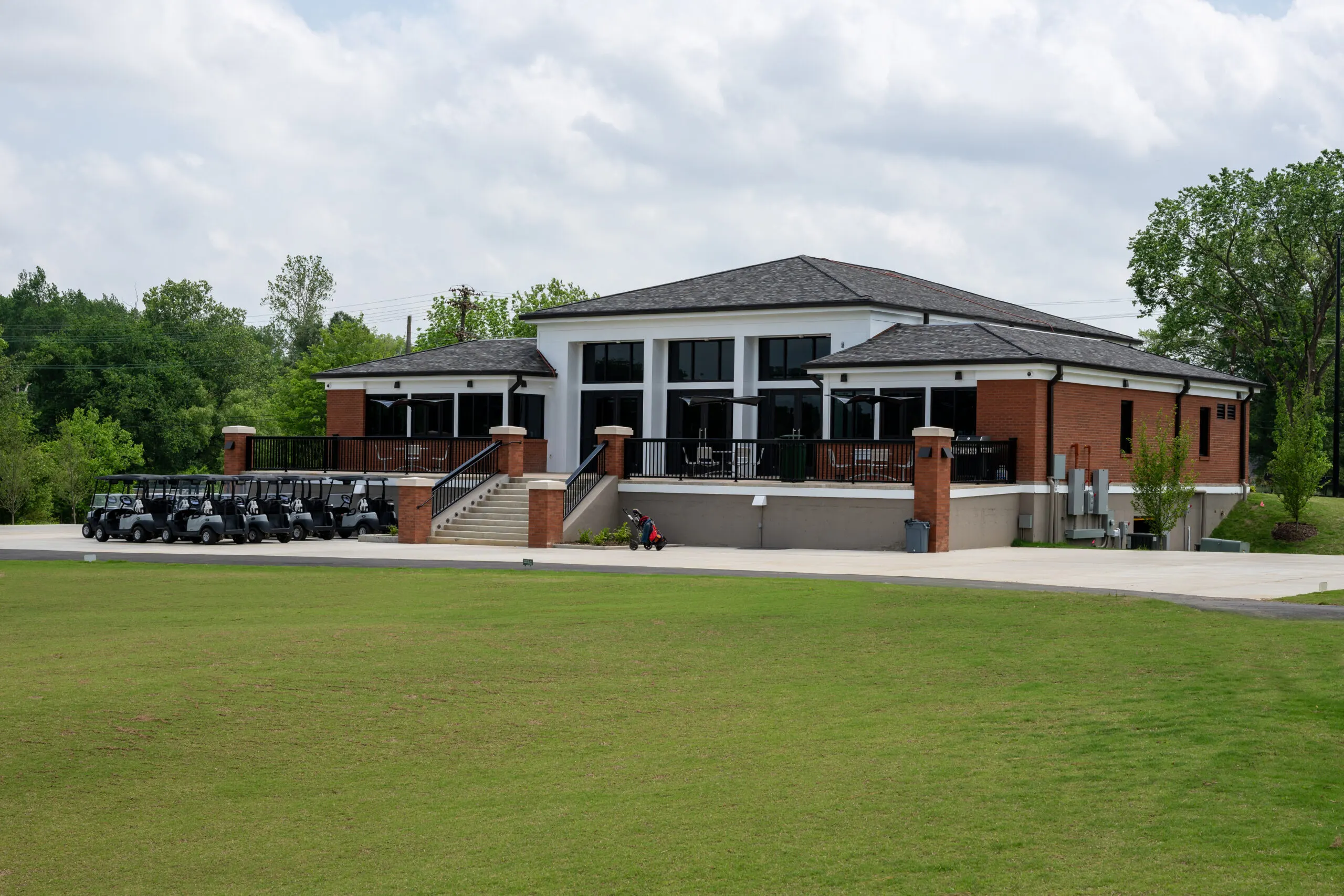 The clubhouse terrace and cart line from the lawn