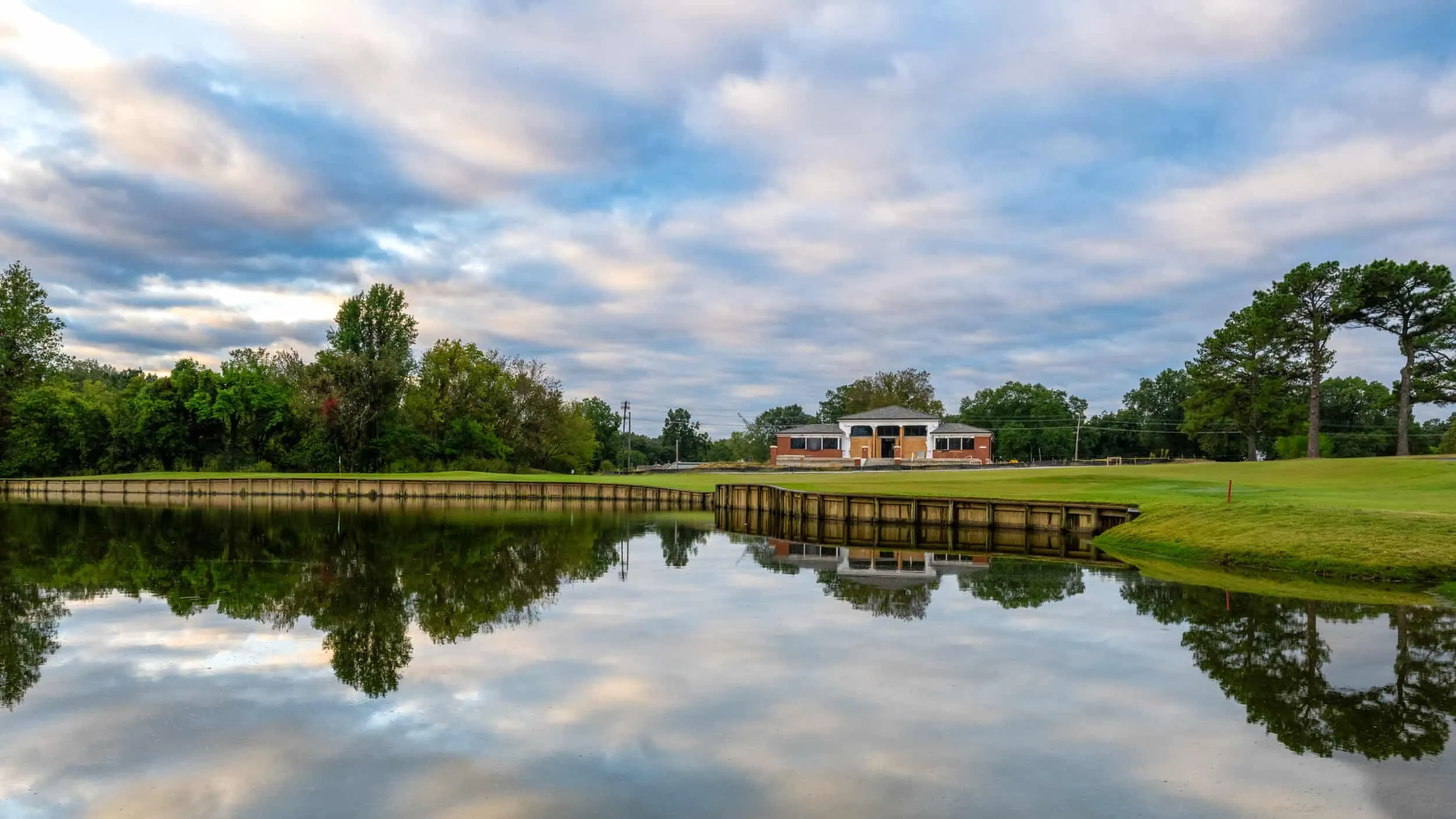 The clubhouse reflected in a still pond