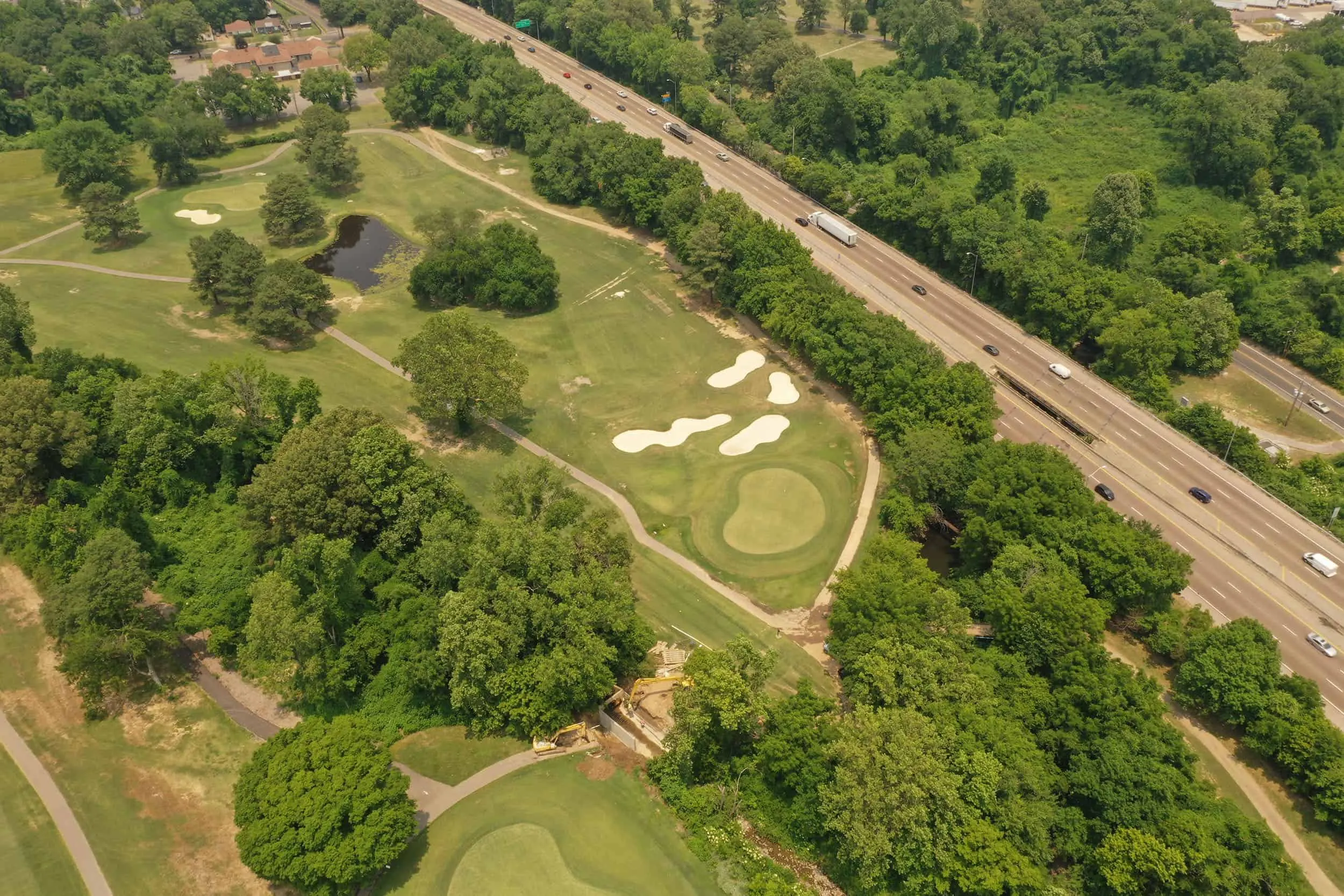 Aerial view of bunkered holes beside the interstate