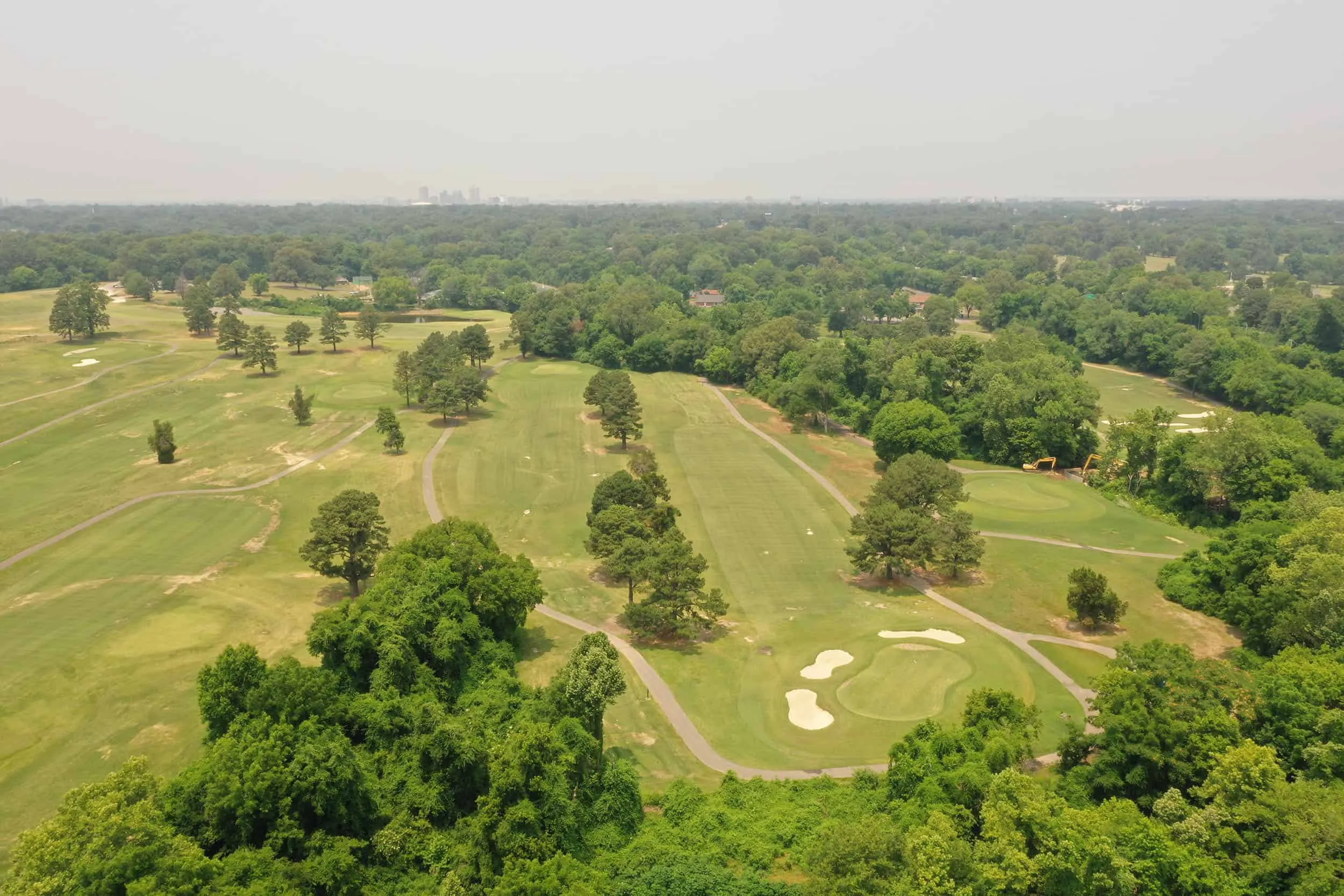 Aerial view down a fairway to the downtown skyline