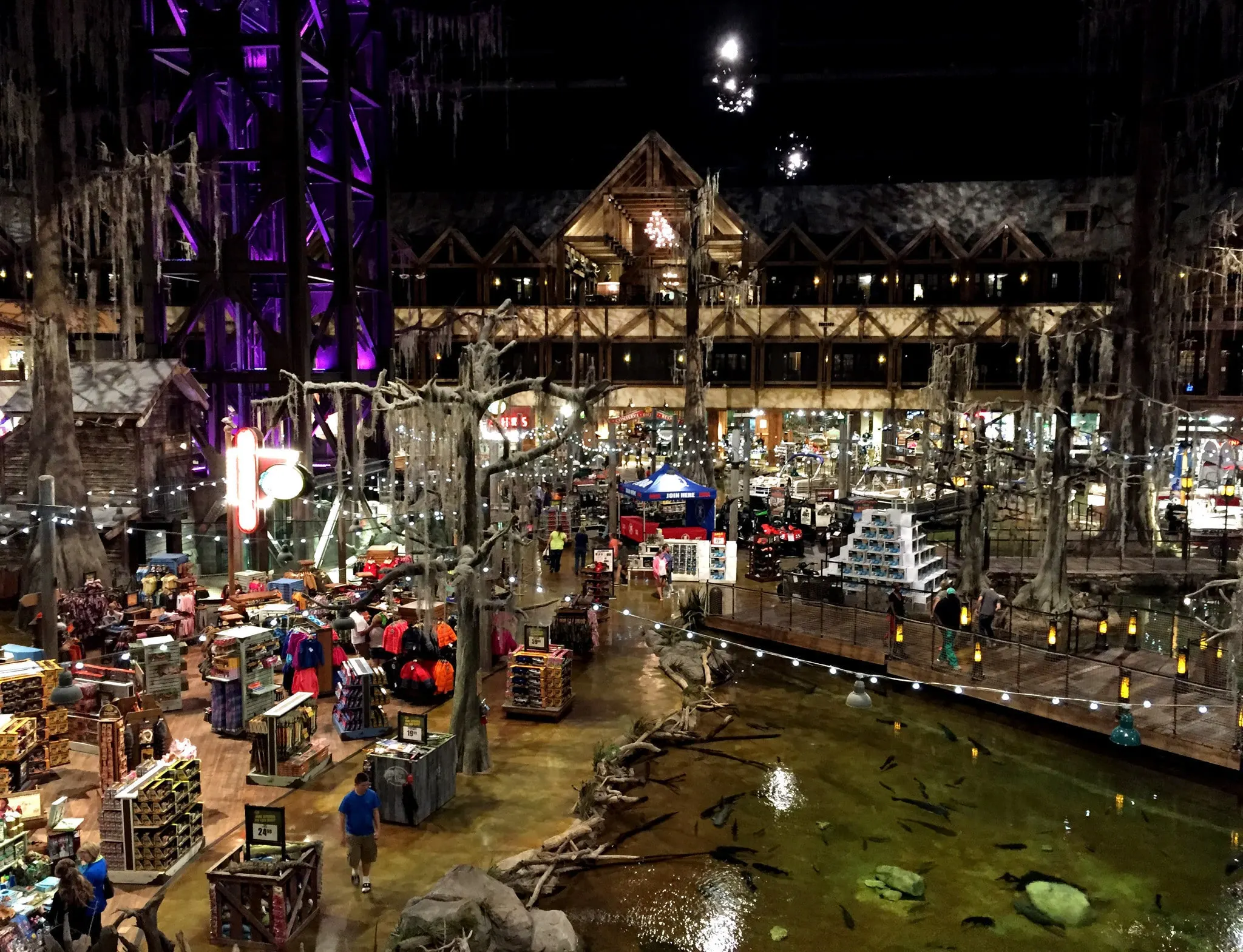 The retail floor at night: cypress trees and a stocked swamp in front of the Big Cypress Lodge facade