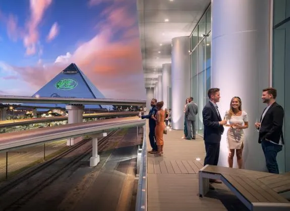 Guests on the balcony at sunset, the Pyramid beyond