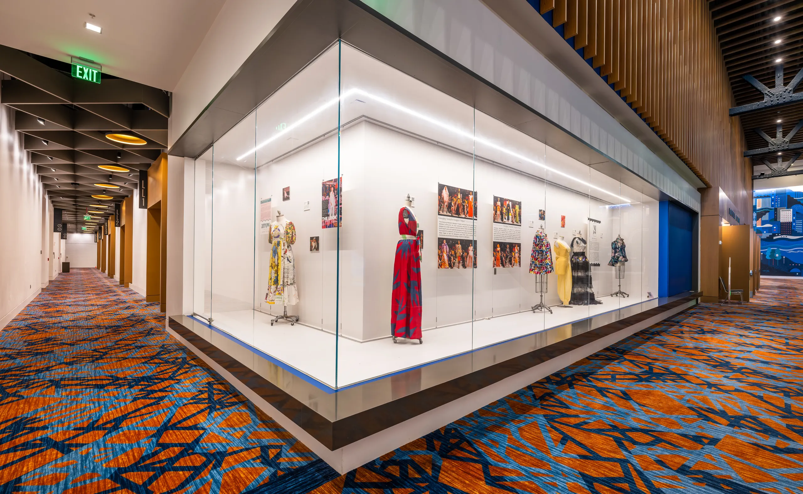 A lit display case of costumes along the concourse