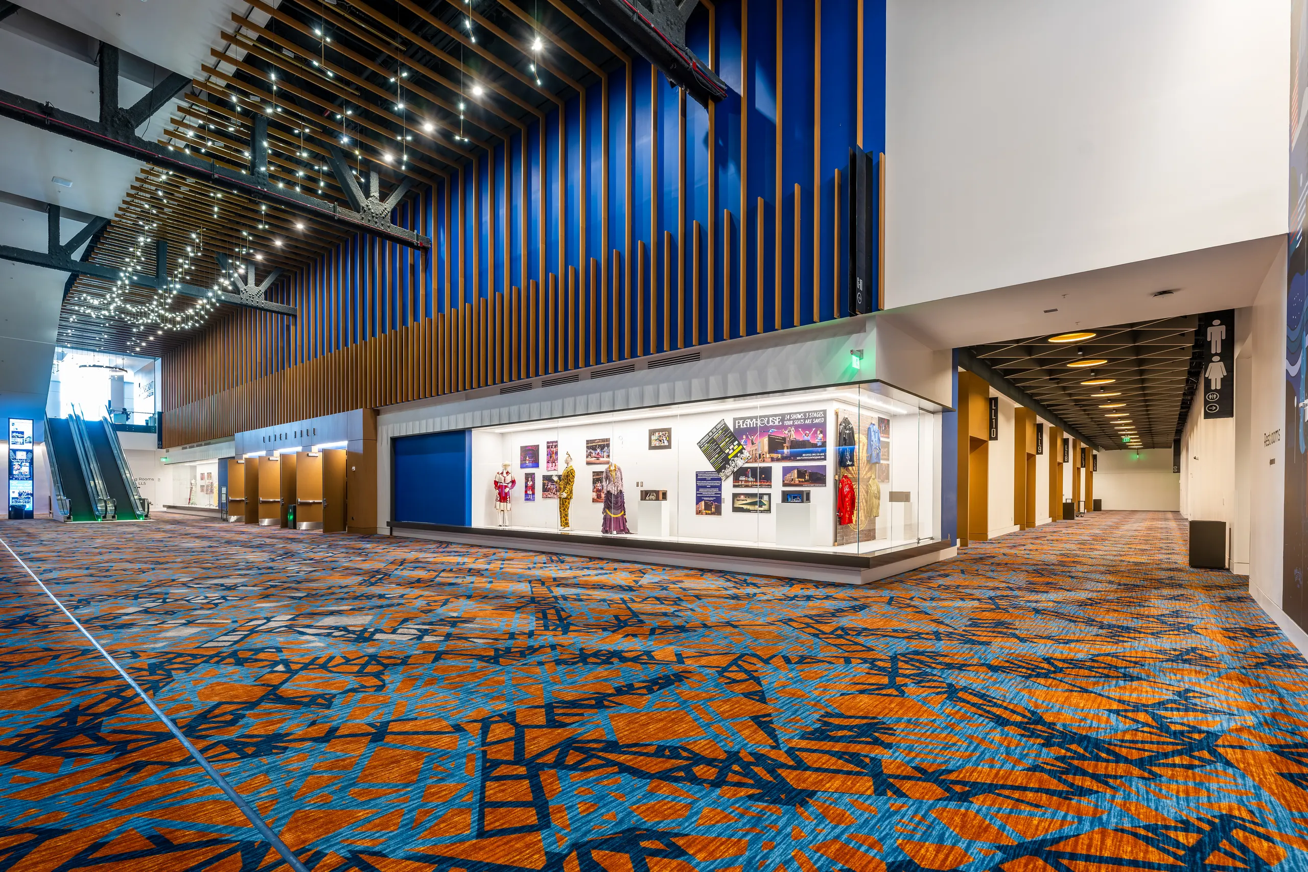 The prefunction concourse with timber slats and a blue feature wall