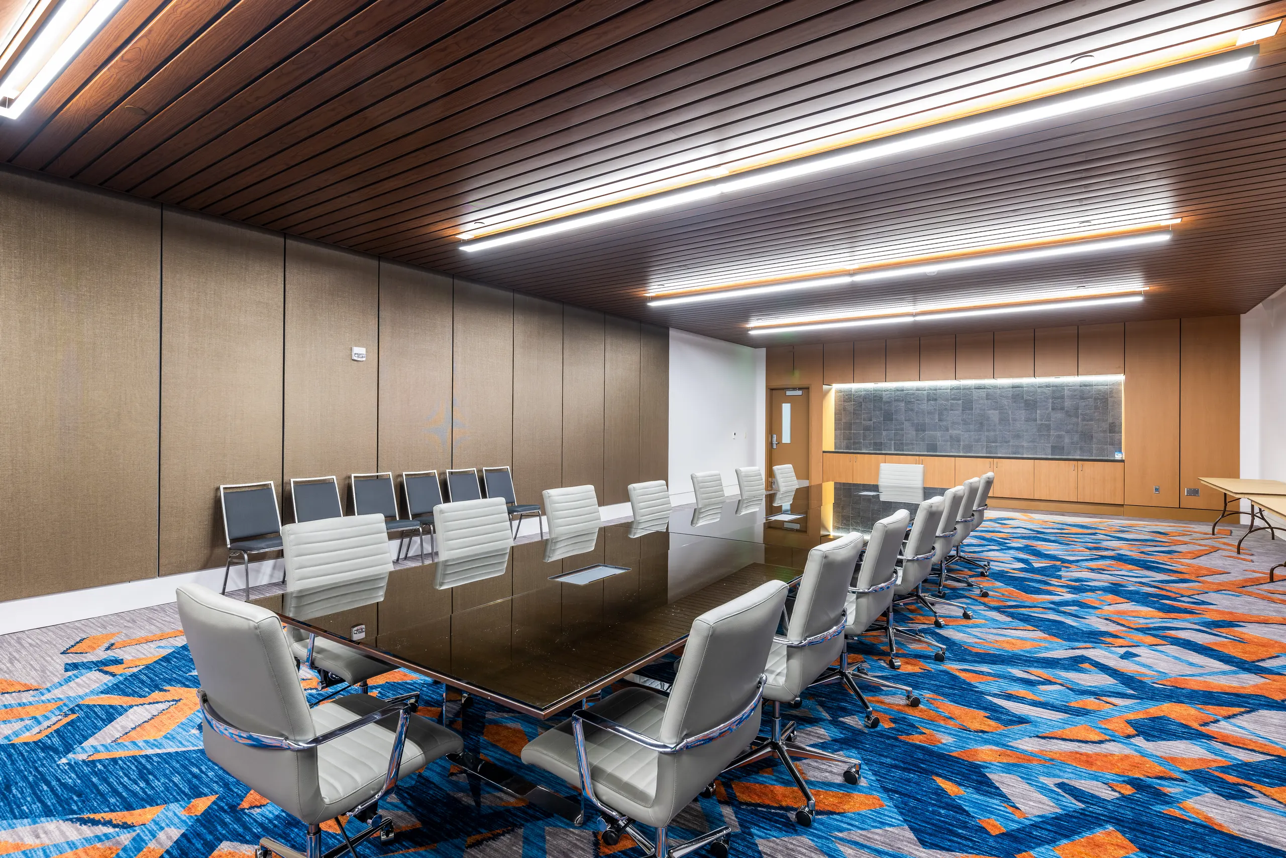 The boardroom with a long table and white chairs