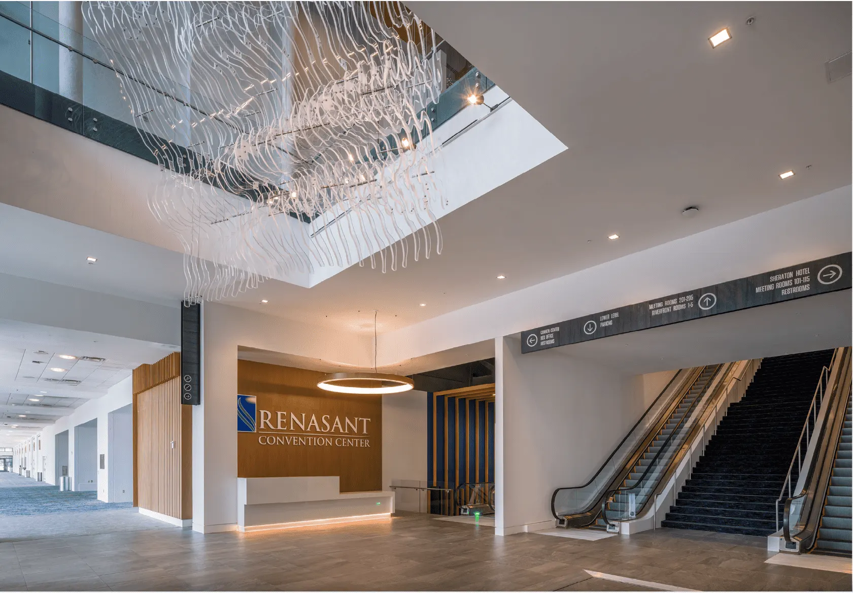 The lobby with a chandelier over the escalators