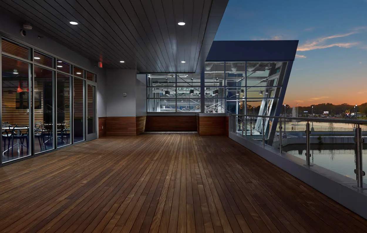 The covered terrace over the water at sunset