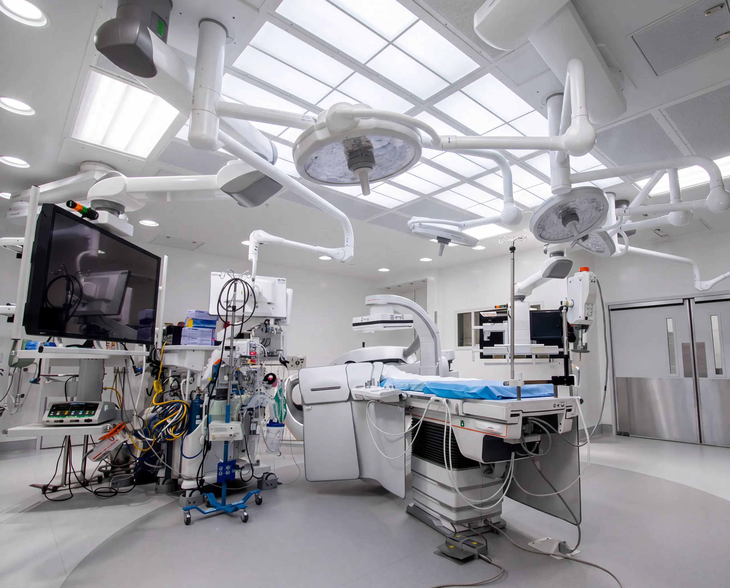 An operating room with surgical lights and imaging equipment