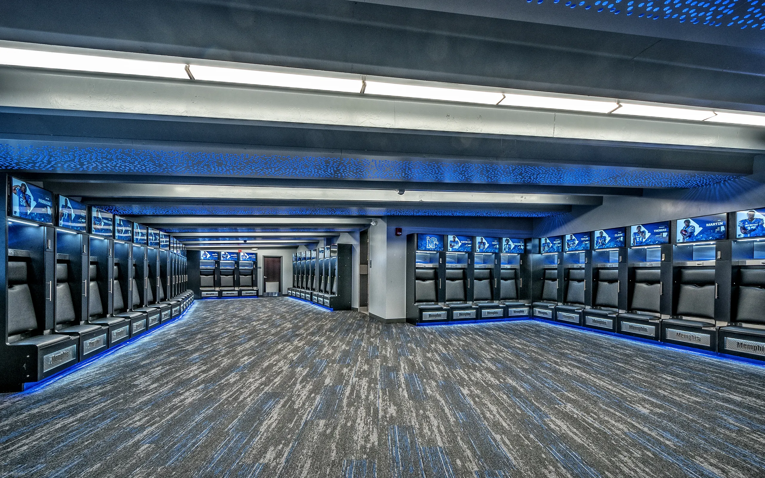The long locker aisle lit in blue