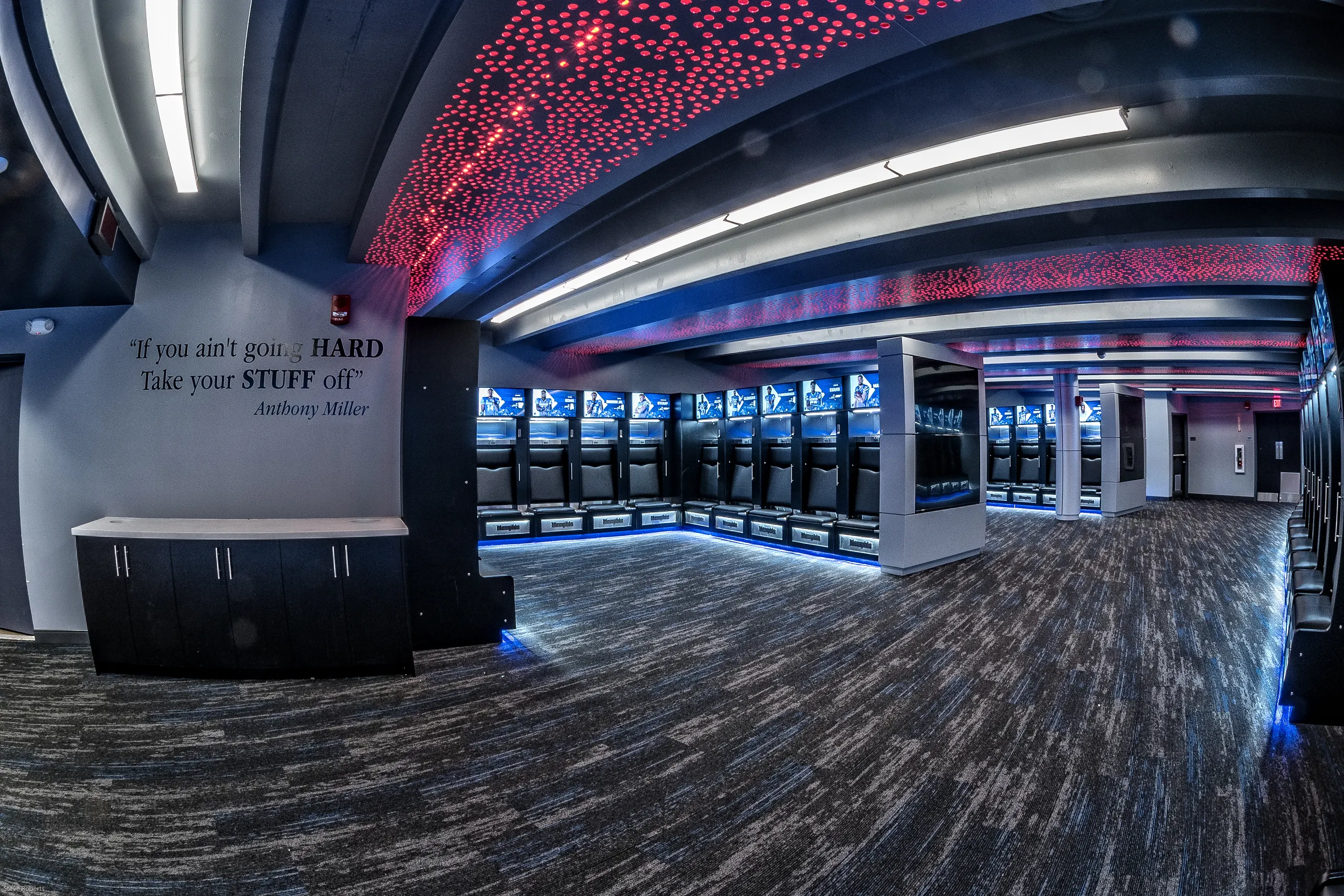 Lockers under a starry red ceiling beside a painted motivational quote
