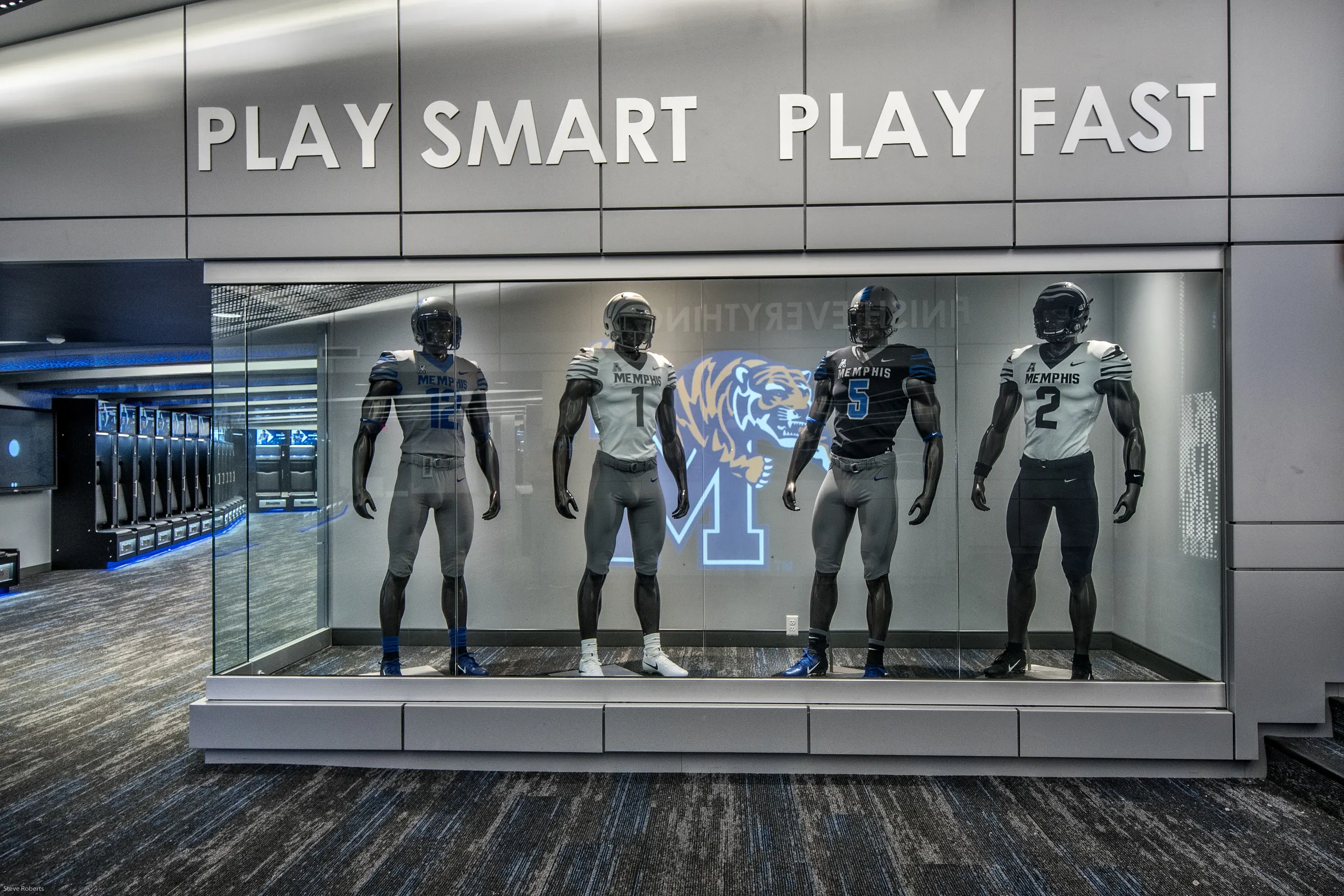 Uniformed mannequins in the display case under Play Smart Play Fast