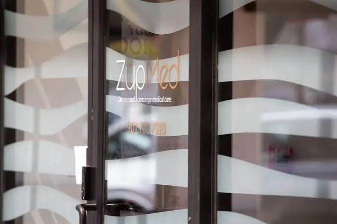 The frosted glass storefront carrying the ZüpMed name